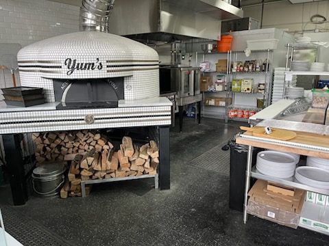 Acunto Napoli Commercial Wood-Fired Pizza Oven with Firewood Storage in Commercial Pizza Kitchen